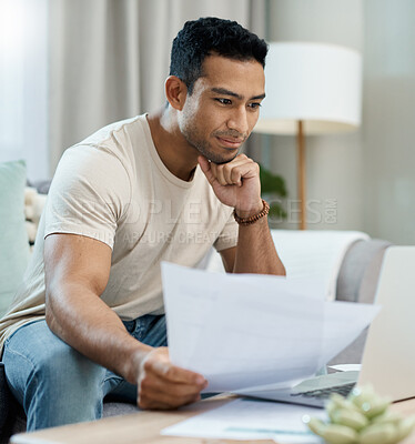 Buy stock photo Home, bills and man on laptop thinking of finance, reading website and taxes or asset management on sofa. Young person with documents for mortgage, budget solution and insurance choice on computer