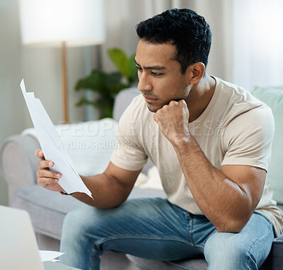 Buy stock photo Serious man, documents and thinking for debt or planning in decision on living room sofa at home. Male person with paperwork in thought or choice for financial plan, expenses or bills at house