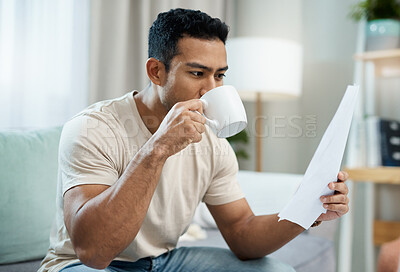 Buy stock photo Asian man, documents and drinking coffee in finance, expenses or checking bills on living room sofa at home. Male person with paperwork, latte or cup of tea and reading contract or insurance at house