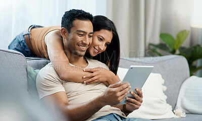 Buy stock photo Happy, hug and couple with tablet on sofa relax with social media, movies or streaming film at home. Love, smile and people in living room with digital, search or app for show, video or communication