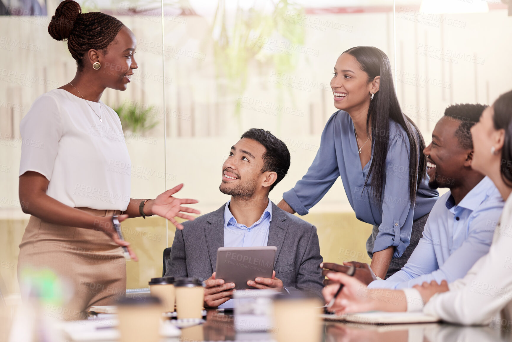 Buy stock photo Shot of a group of coworkers using a digital tablet during a business meeting