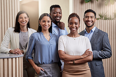 Buy stock photo Shot of a team of businesspeople together in their office with their arms crossed