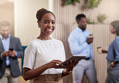 Buy stock photo Shot of a young businessman using her digital tablet at work