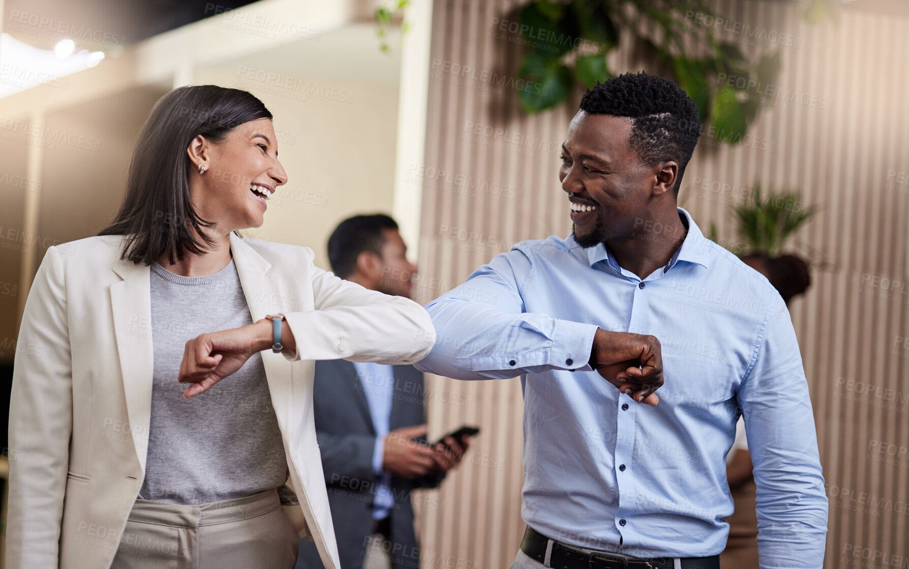 Buy stock photo Shot of two business colleagues bumping elbows in a covid safe greeting