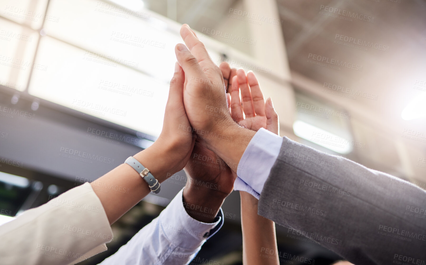 Buy stock photo Shot of a group of business people high fiving each other