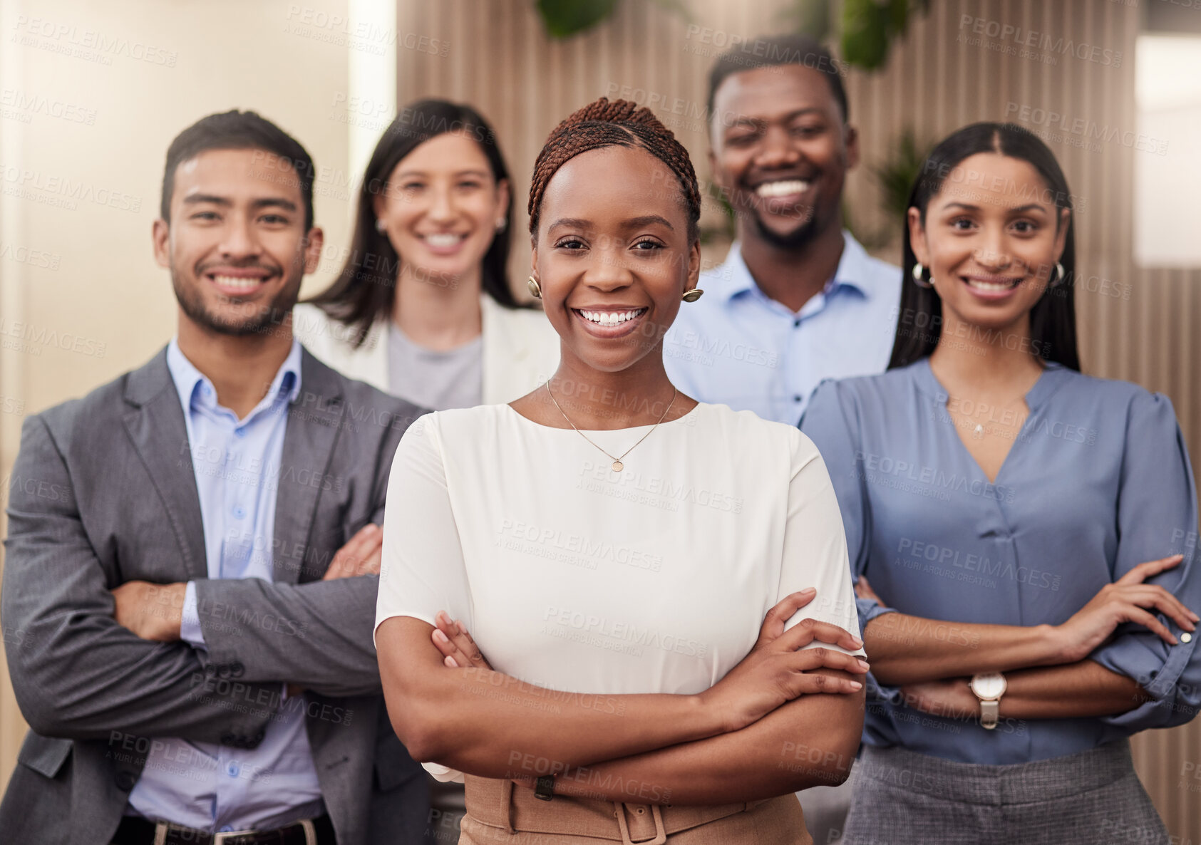 Buy stock photo Shot of a team of businesspeople together in their office with their arms crossed