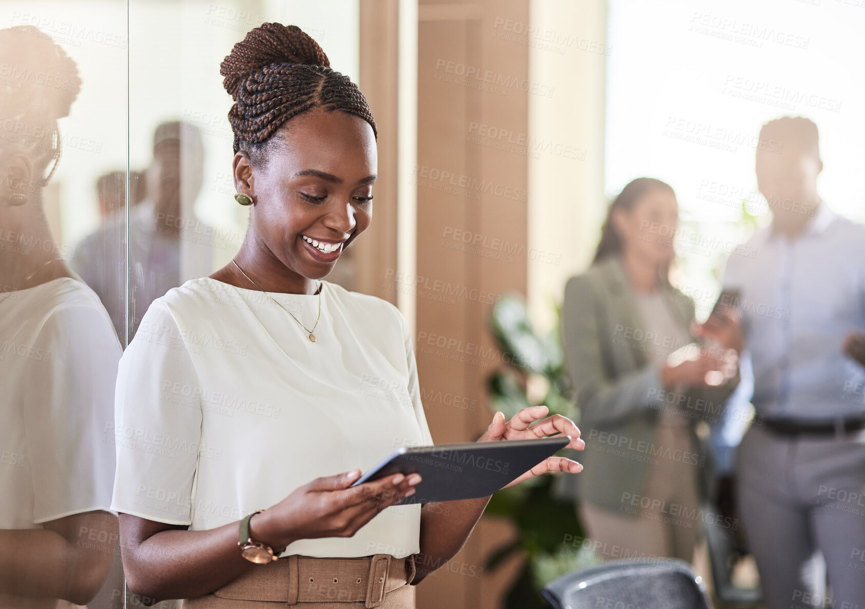 Buy stock photo Shot of a young businesswoman using her digital tablet