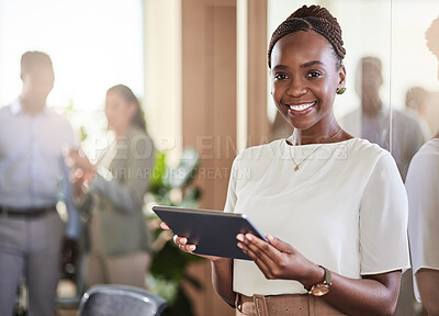 Buy stock photo Shot of a young businesswoman using her digital tablet