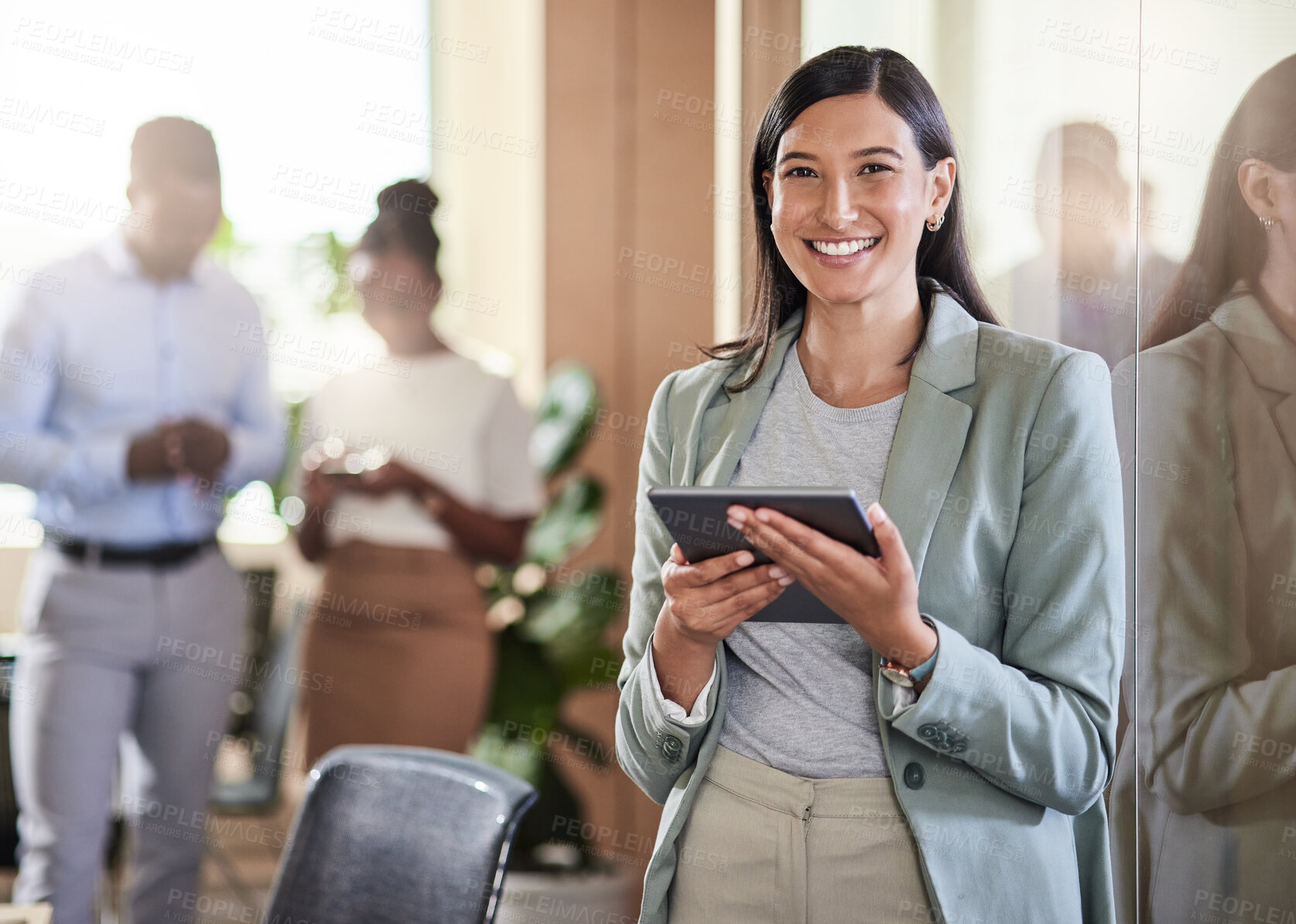 Buy stock photo Shot of a young businesswoman using her digital tablet