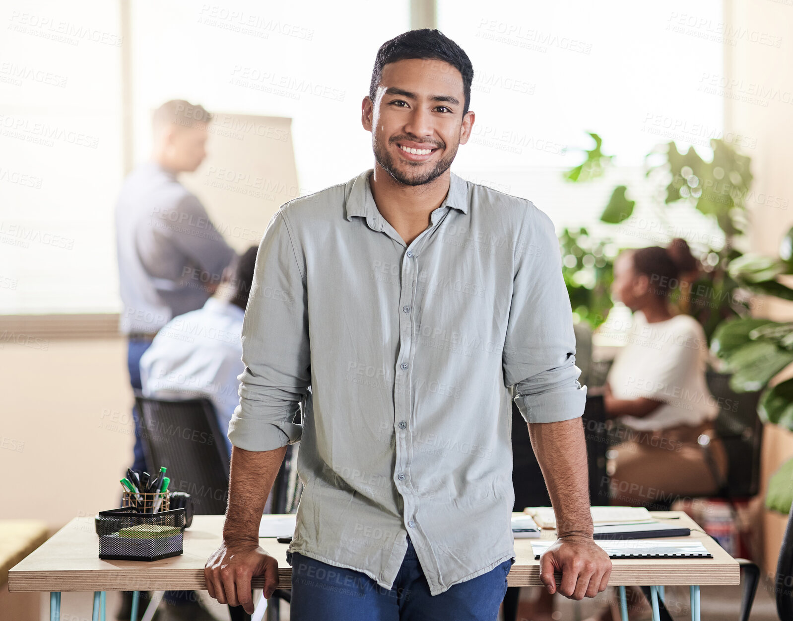 Buy stock photo Shot of a handsome young businessman at work