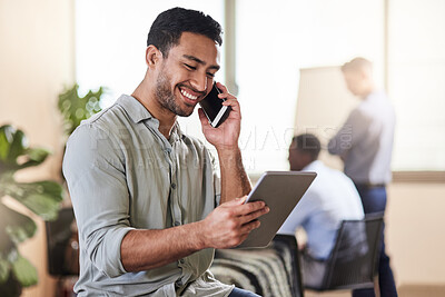 Buy stock photo Shot of a young businessman using his smartphone to make a phone call while holding his digital tablet