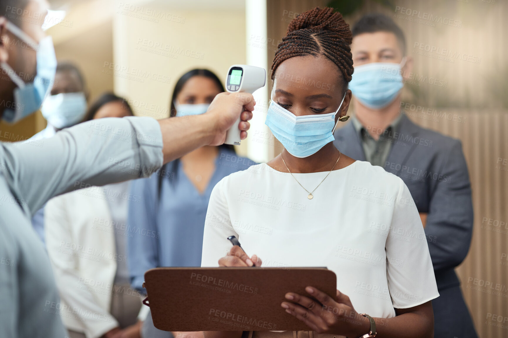 Buy stock photo Cropped shot of an attractive young businesswoman wearing a mask and going through covid screen while standing at the head of a queue in her office