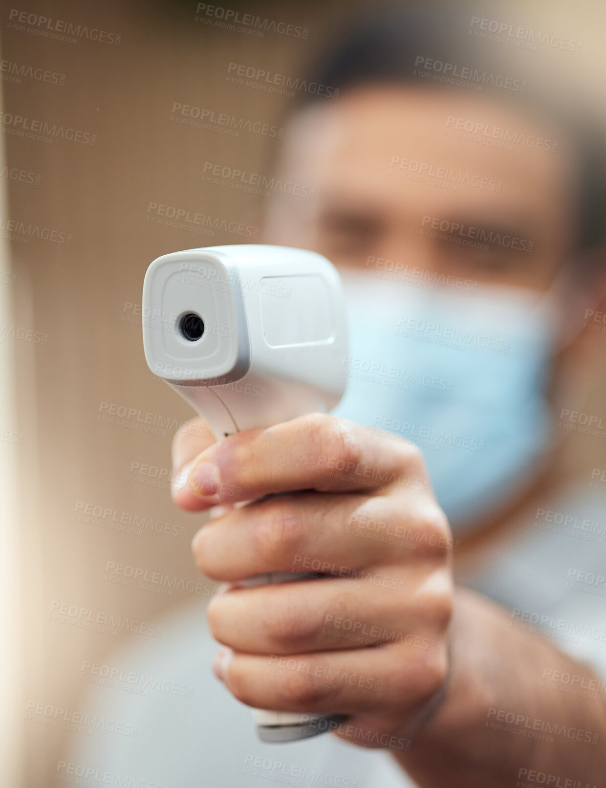 Buy stock photo Cropped shot of an unrecognizable man ready to take your temperature using a digital thermometer in the workplace