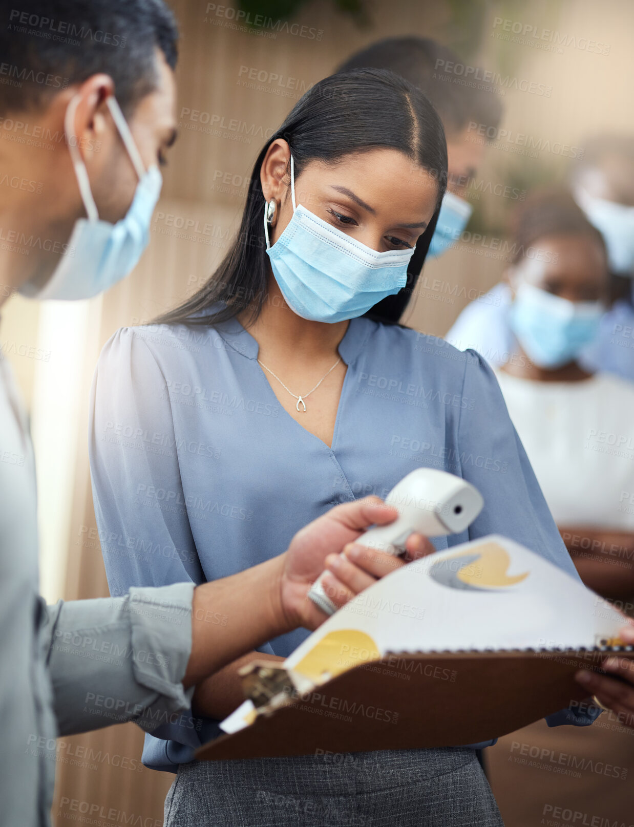 Buy stock photo Cropped shot of an attractive young businesswoman wearing a mask and going through covid screen while standing at the head of a queue in her office