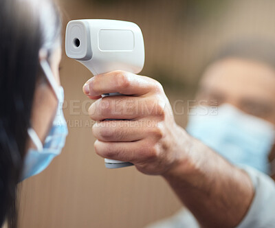 Buy stock photo Cropped shot of an unrecognizable businesswoman wearing a mask and having her temperature taken while standing at the head of a queue in her office