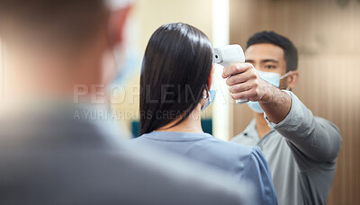 Buy stock photo Cropped shot of an unrecognizable businesswoman wearing a mask and having her temperature taken while standing at the head of a queue in her office