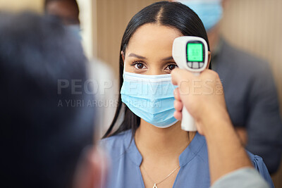 Buy stock photo Cropped shot of an attractive young businesswoman wearing a mask and having her temperature taken while standing at the head of a queue in her office