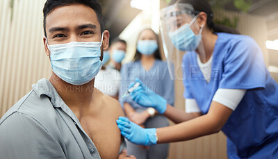Buy stock photo Cropped portrait of a handsome young businessman getting his covid vaccination from a female nurse in the office