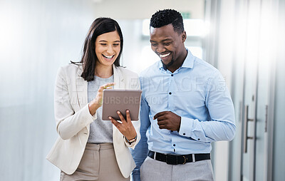 Buy stock photo Shot of two businesspeople discussing something on a digital tablet