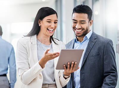 Buy stock photo Shot of two businesspeople discussing something on a digital tablet