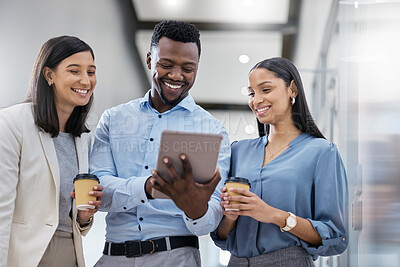 Buy stock photo Shot of three businesspeople discussing something on a digital tablet