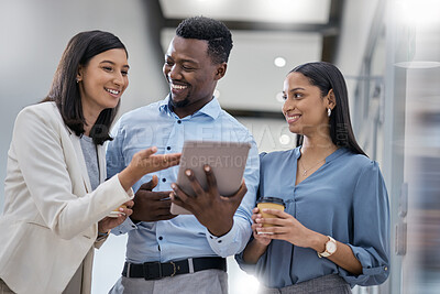 Buy stock photo Shot of three businesspeople discussing something on a digital tablet