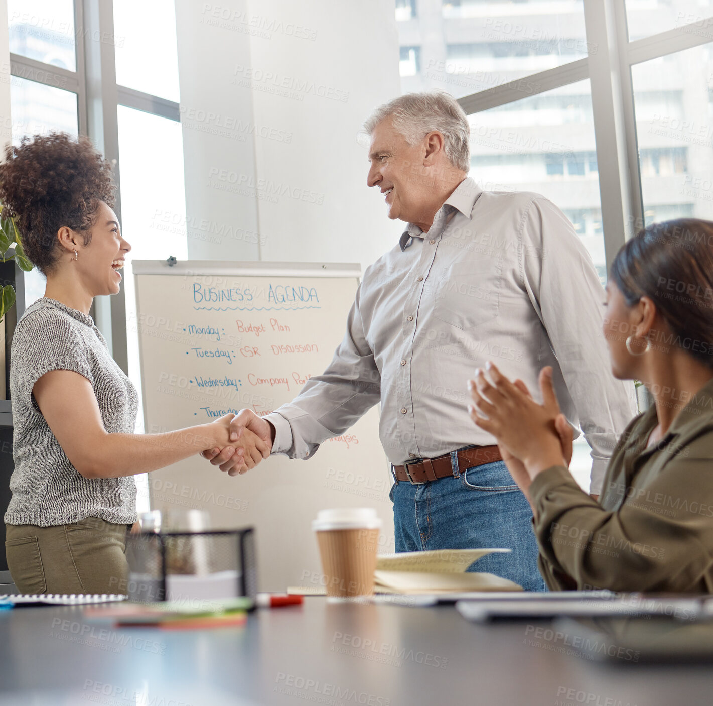 Buy stock photo Shot of two businesspeople shaking hands in a meeting at work