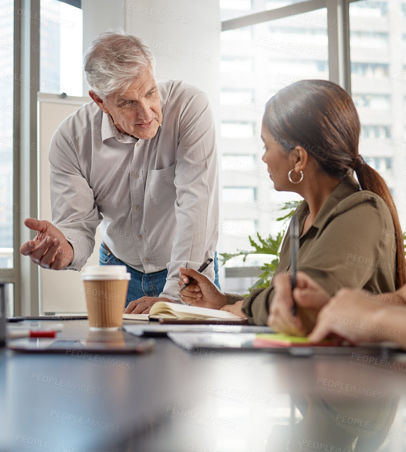 Buy stock photo Shot of a mature businessman talking in a meeting at work