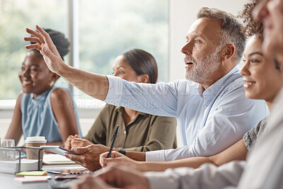 Buy stock photo Shot of a mature bussinessman raising his hand in a meeting at work