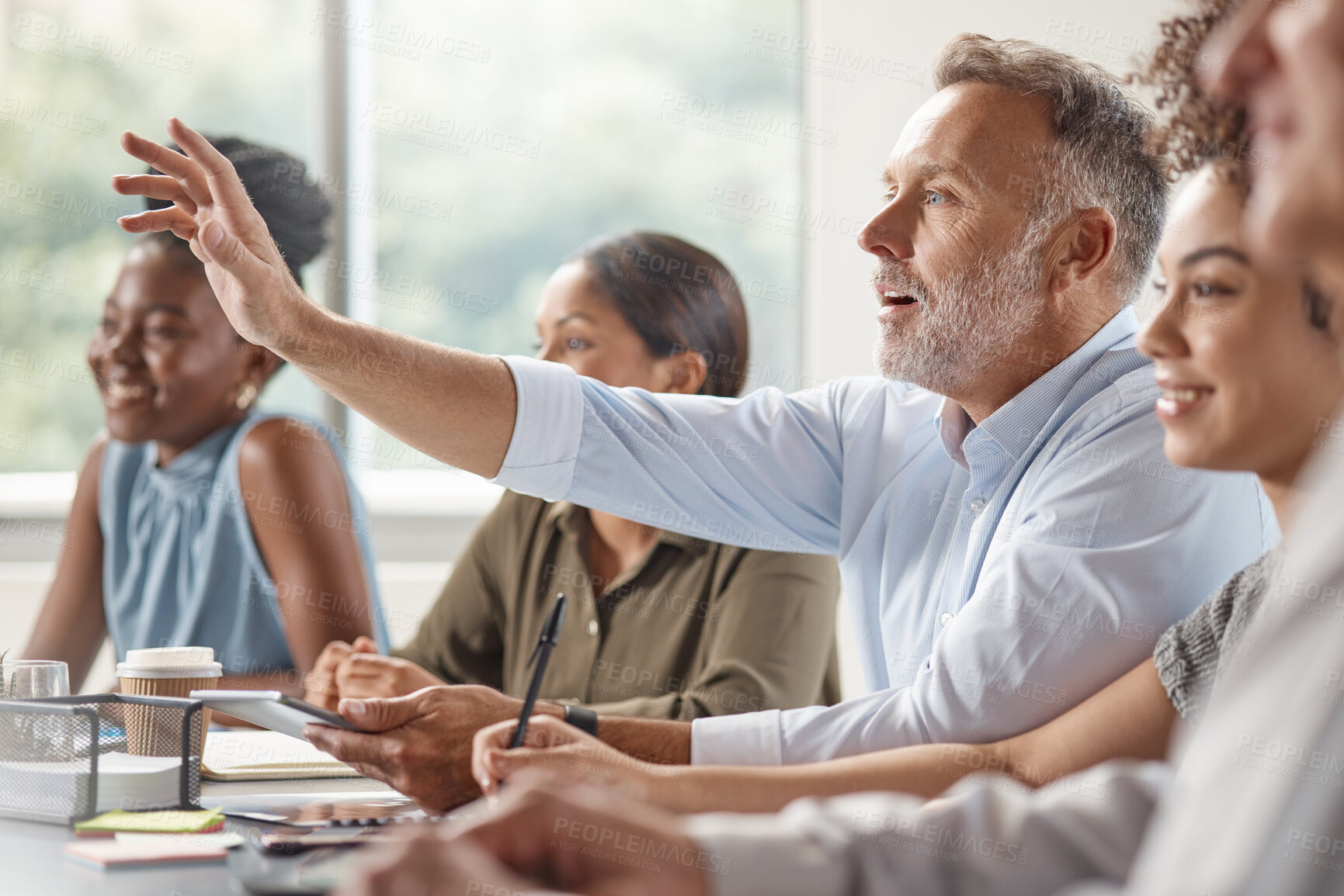 Buy stock photo Shot of a mature bussinessman raising his hand in a meeting at work