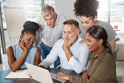 Buy stock photo Shot of a group of businesspeople using a laptop at work