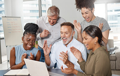 Buy stock photo Shot of a group of businesspeople using a laptop at work