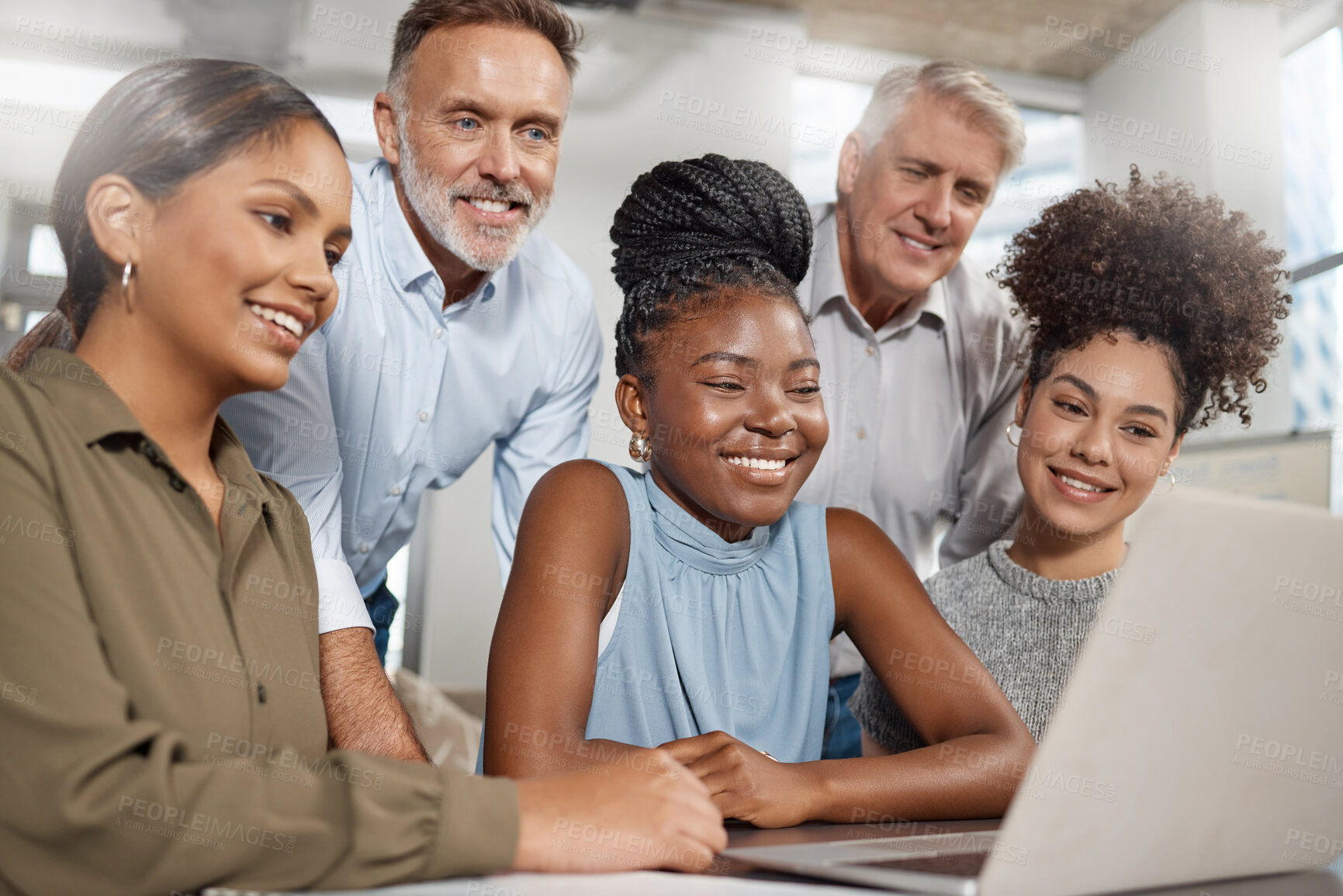 Buy stock photo Shot of a group of businesspeople using a laptop at work