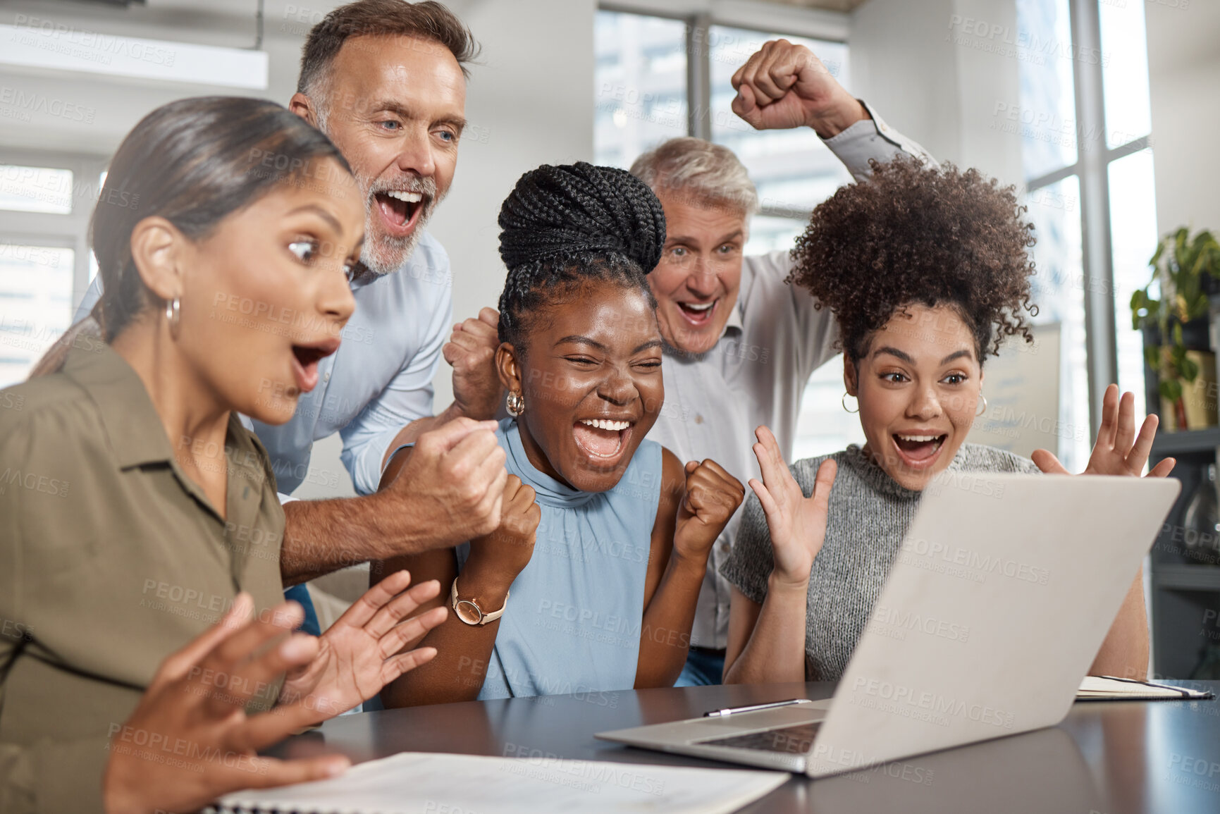 Buy stock photo Shot of a group of businesspeople using a laptop at work