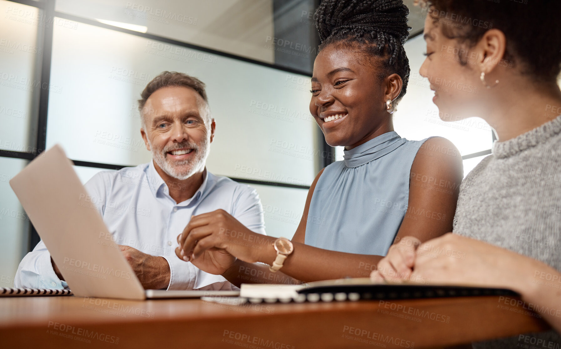 Buy stock photo Shot of a group of businesspeople using a laptop at work