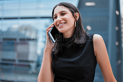 Buy stock photo Cropped shot of an attractive young businesswoman making a phonecall while standing outside on the office balcony