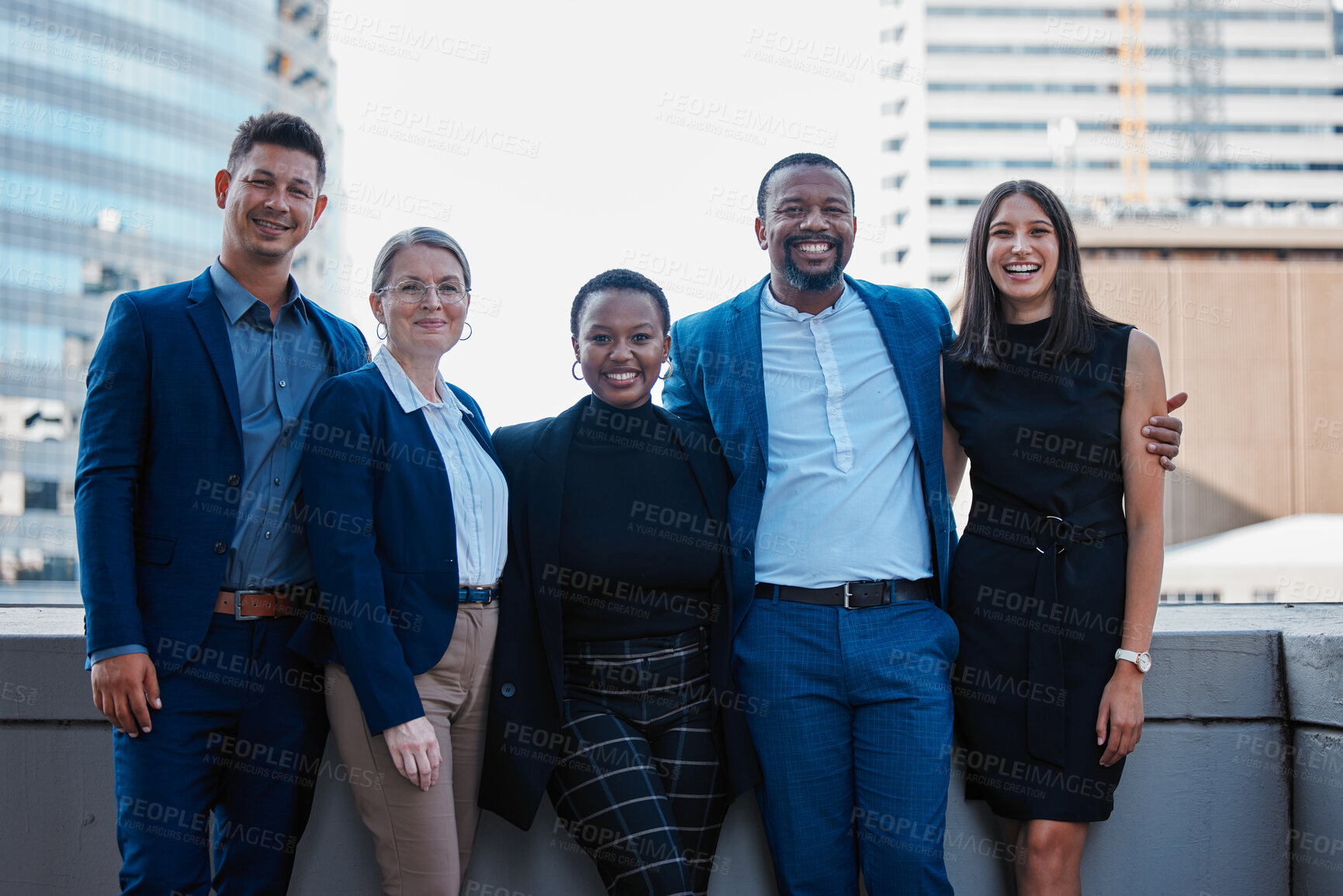 Buy stock photo Cropped portrait of a diverse group of businesspeople standing together outside on their office balcony