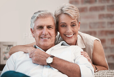Buy stock photo Portrait of an affection mature couple posing for a picture on the sofa together at home
