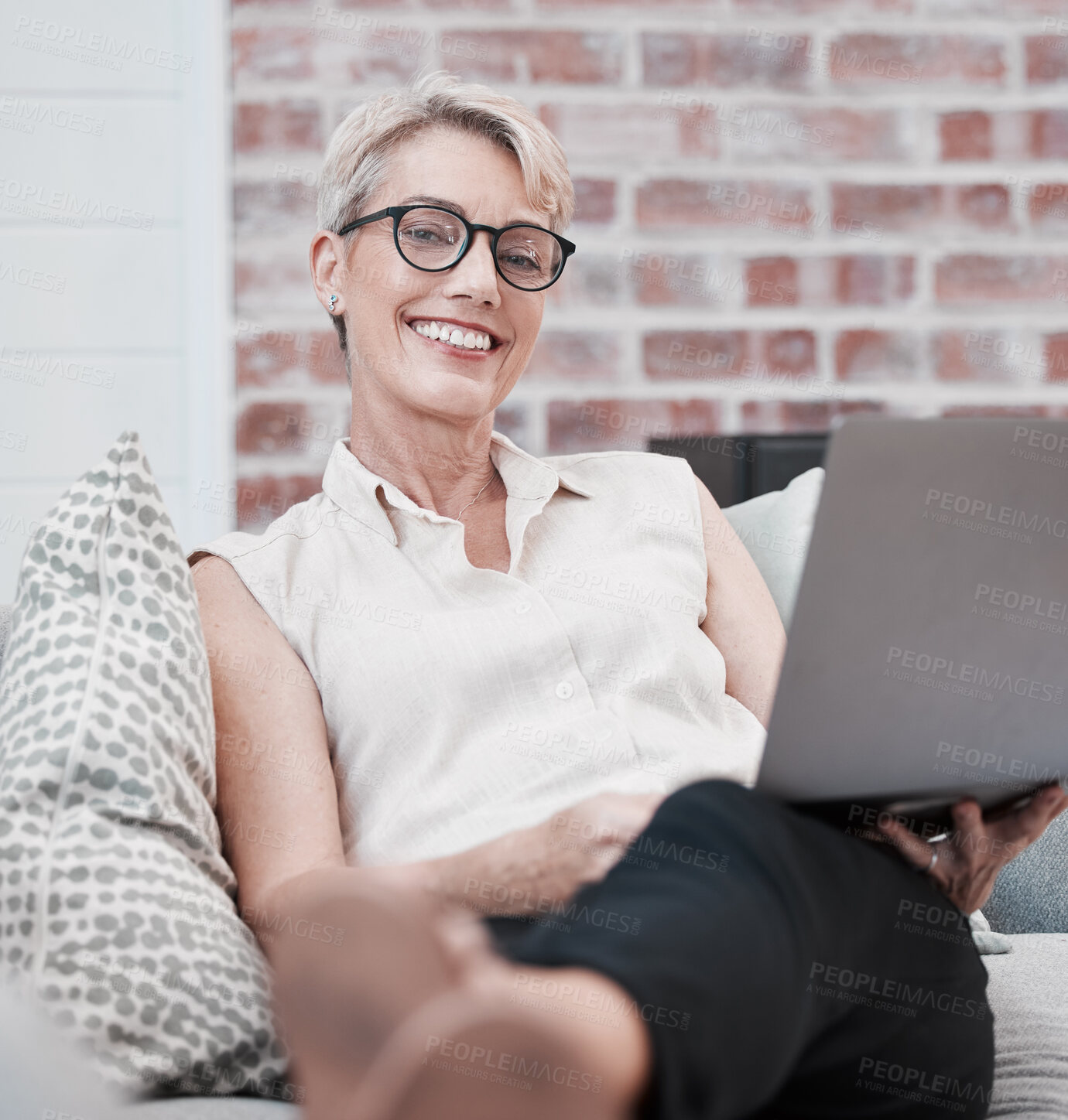 Buy stock photo Mature woman, laptop and portrait on couch with website for social media update, chat app and reading blog post. Sofa, senior female person with computer for check credit score and internet research