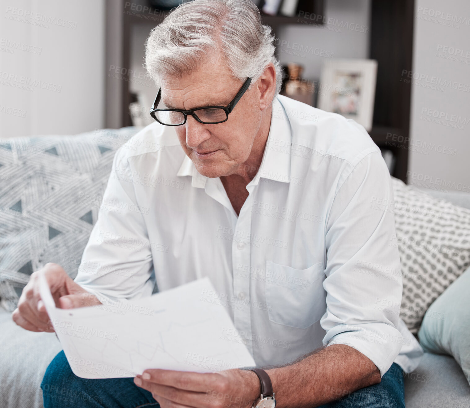 Buy stock photo Document, reading and senior man on sofa planning mortgage, bills and debt payments at home. Receipt, saving and elderly male person with finance paperwork for pension fund in living room at house.
