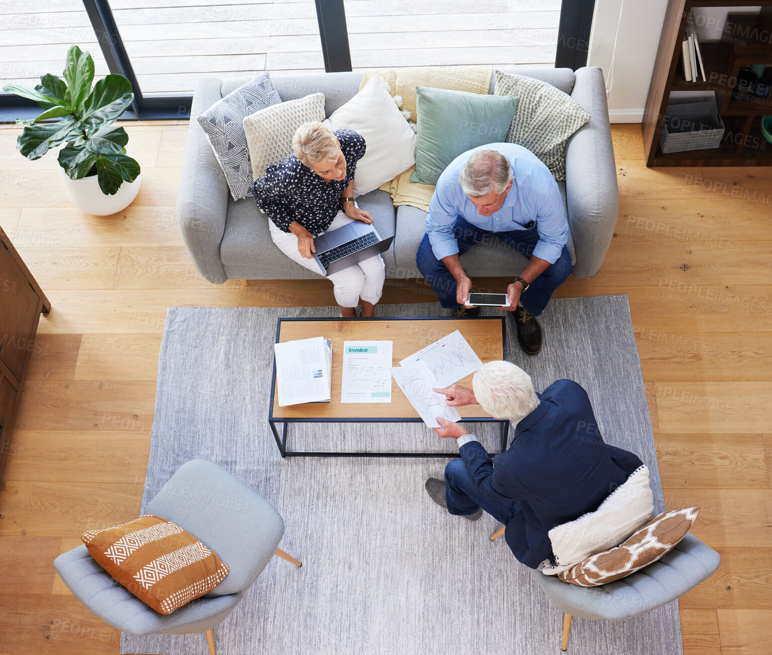 Buy stock photo Aerial shot of a group of businesspeople going through paperwork