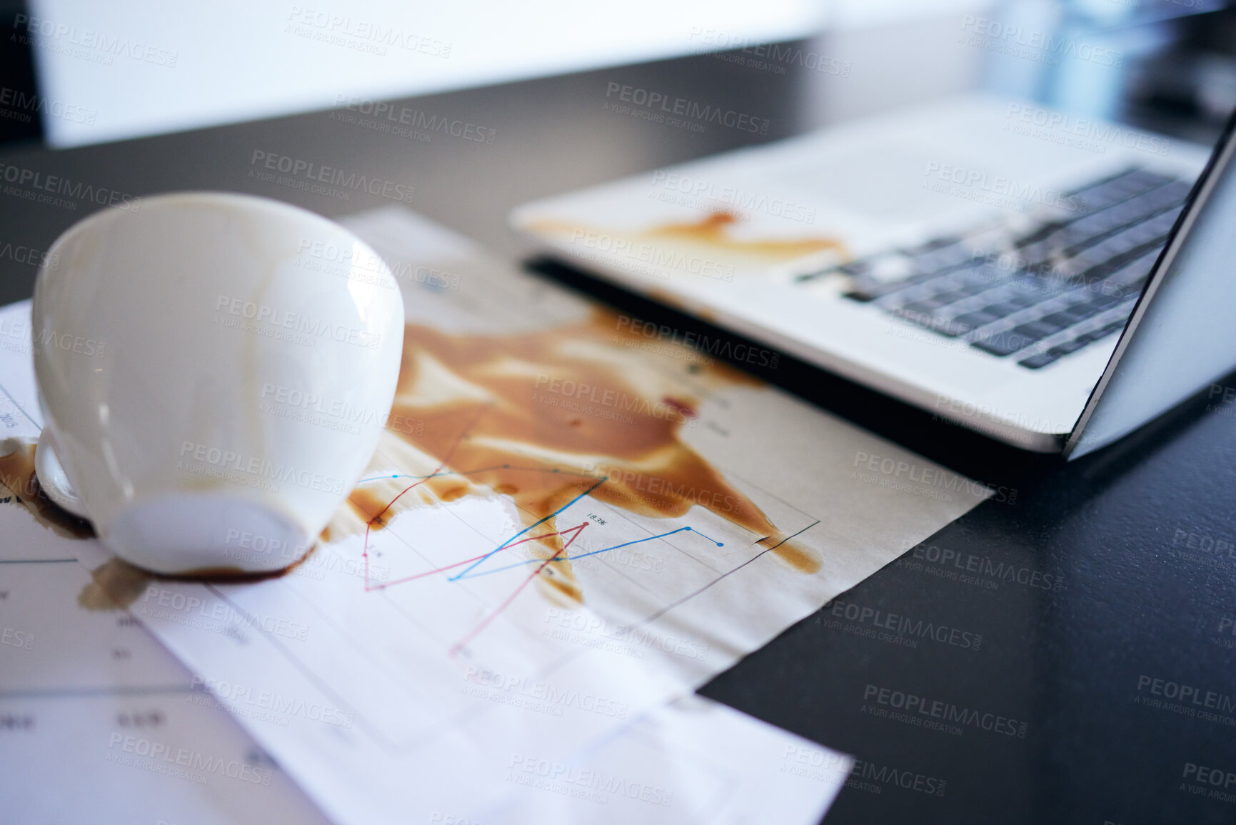 Buy stock photo Laptop, documents and coffee spill, mistake or accident in empty office workplace interior. Computer, spilling tea and business paperwork, graphs or charts, tech damage and error, problem or clumsy.