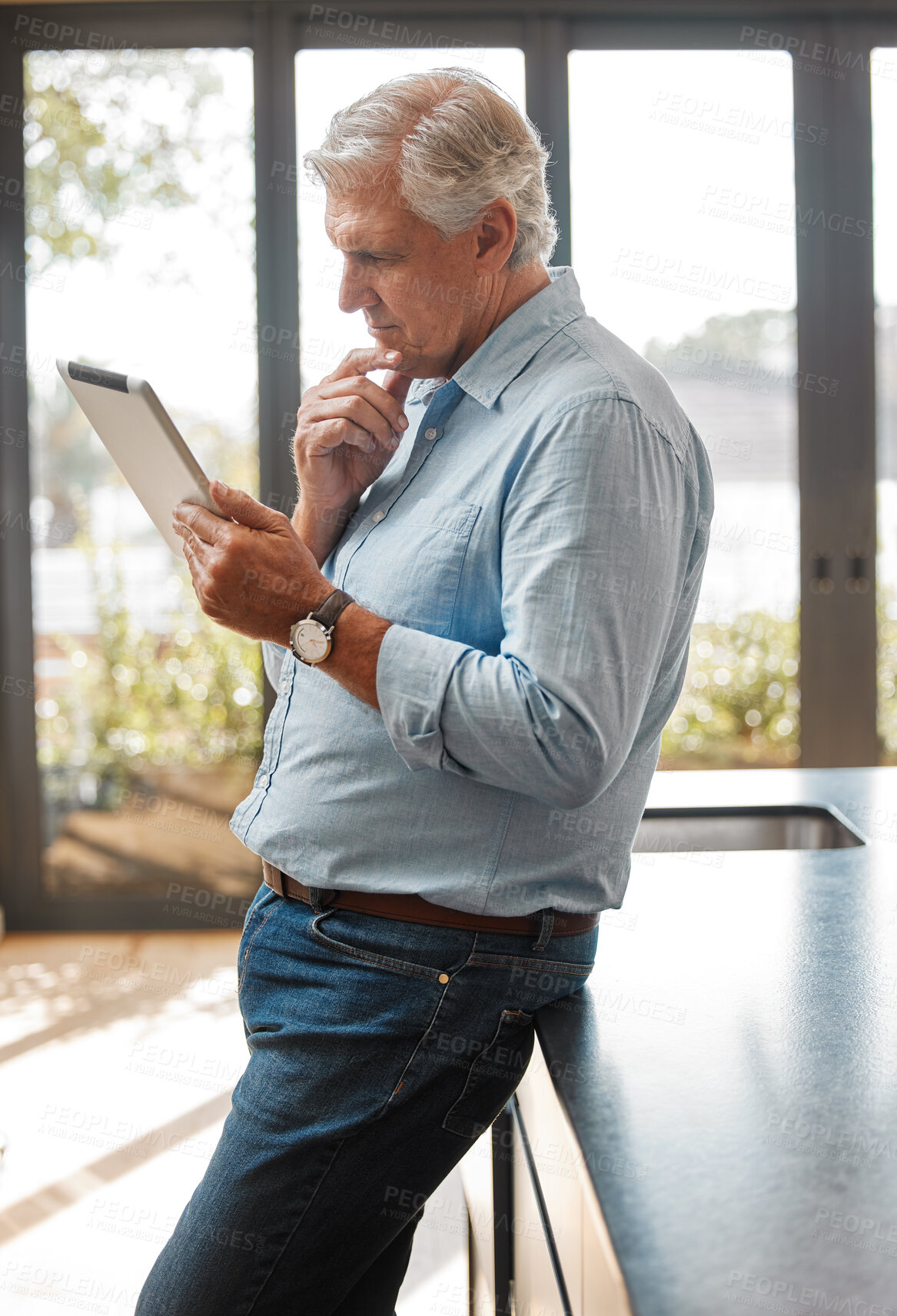 Buy stock photo Shot of a senior male realtor using a digital tablet