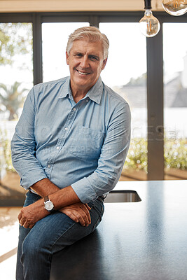 Buy stock photo Shot of a senior male realtor leaning on a counter at a house