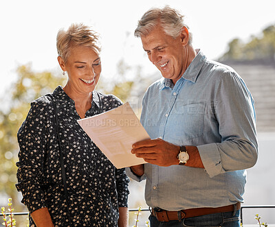 Buy stock photo Shot of a senior male realtor going through paperwork with a client