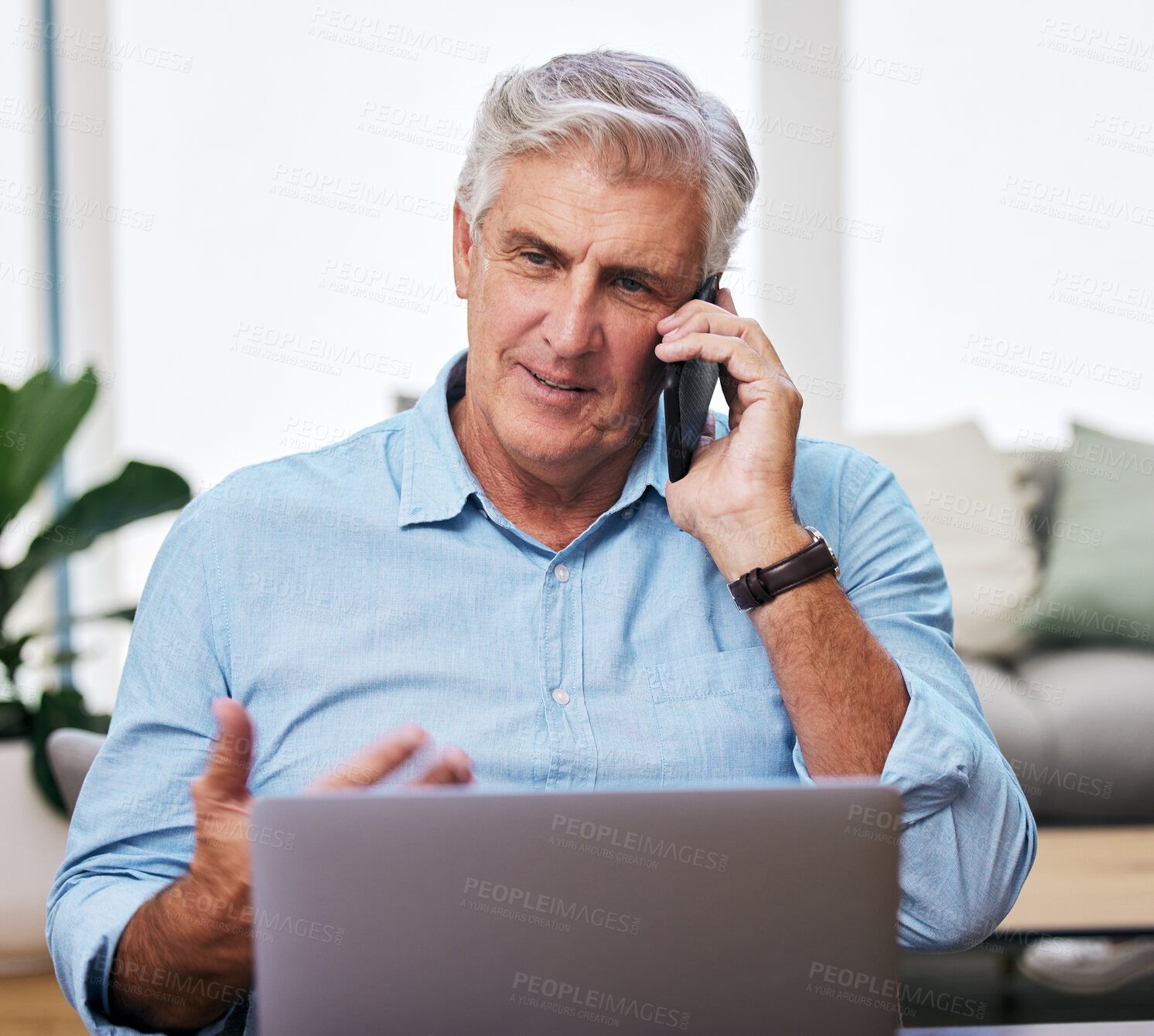 Buy stock photo Shot of a mature man using his cellphone and laptop while working from home