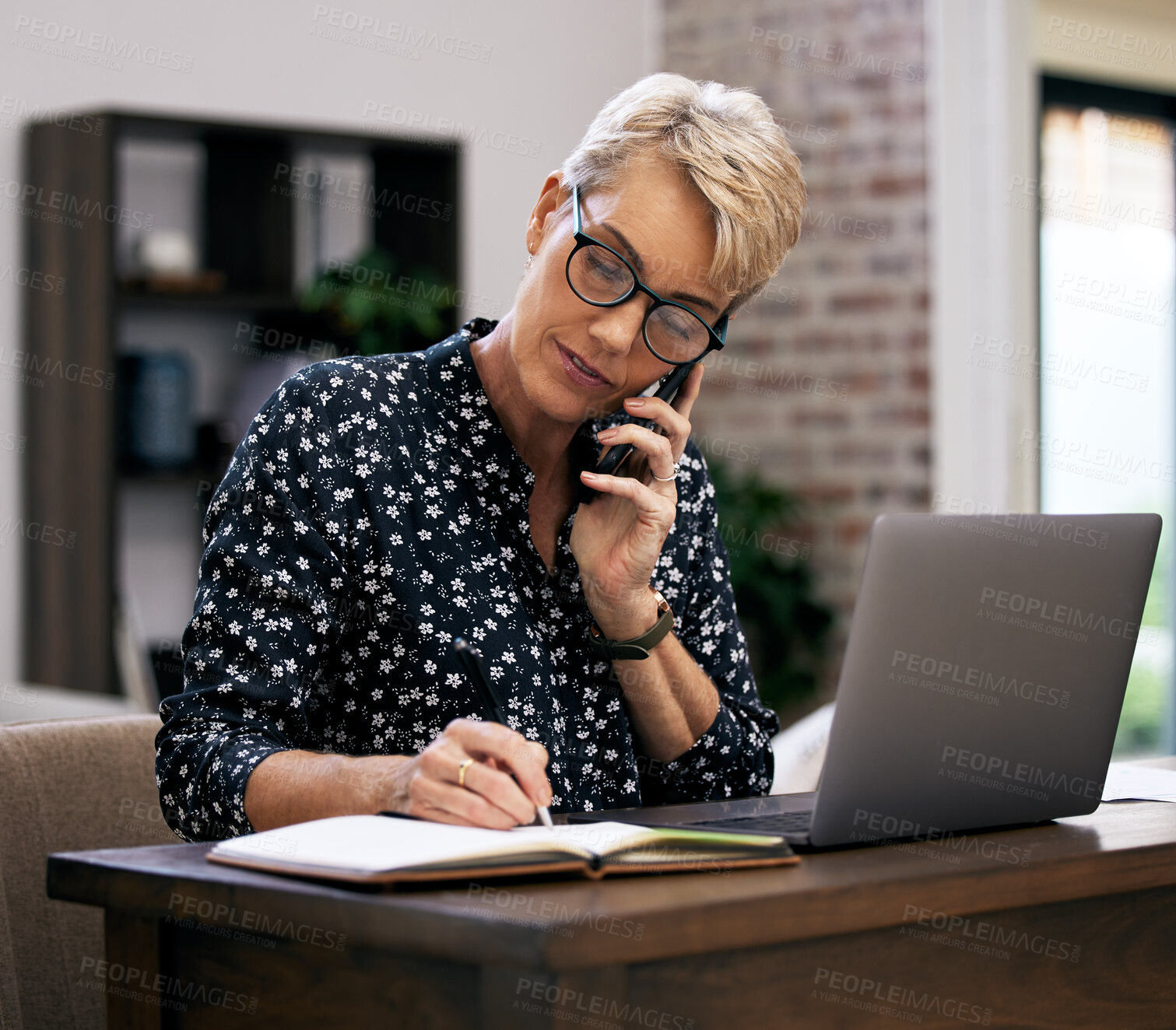 Buy stock photo Phone call, laptop and mature woman with notes in office with corporate company communication. Technology and female hr manager writing for business dispute with computer on mobile discussion.