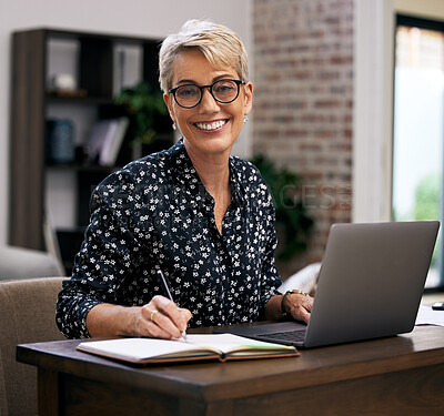 Buy stock photo Shot of a mature woman using her laptop while working from home