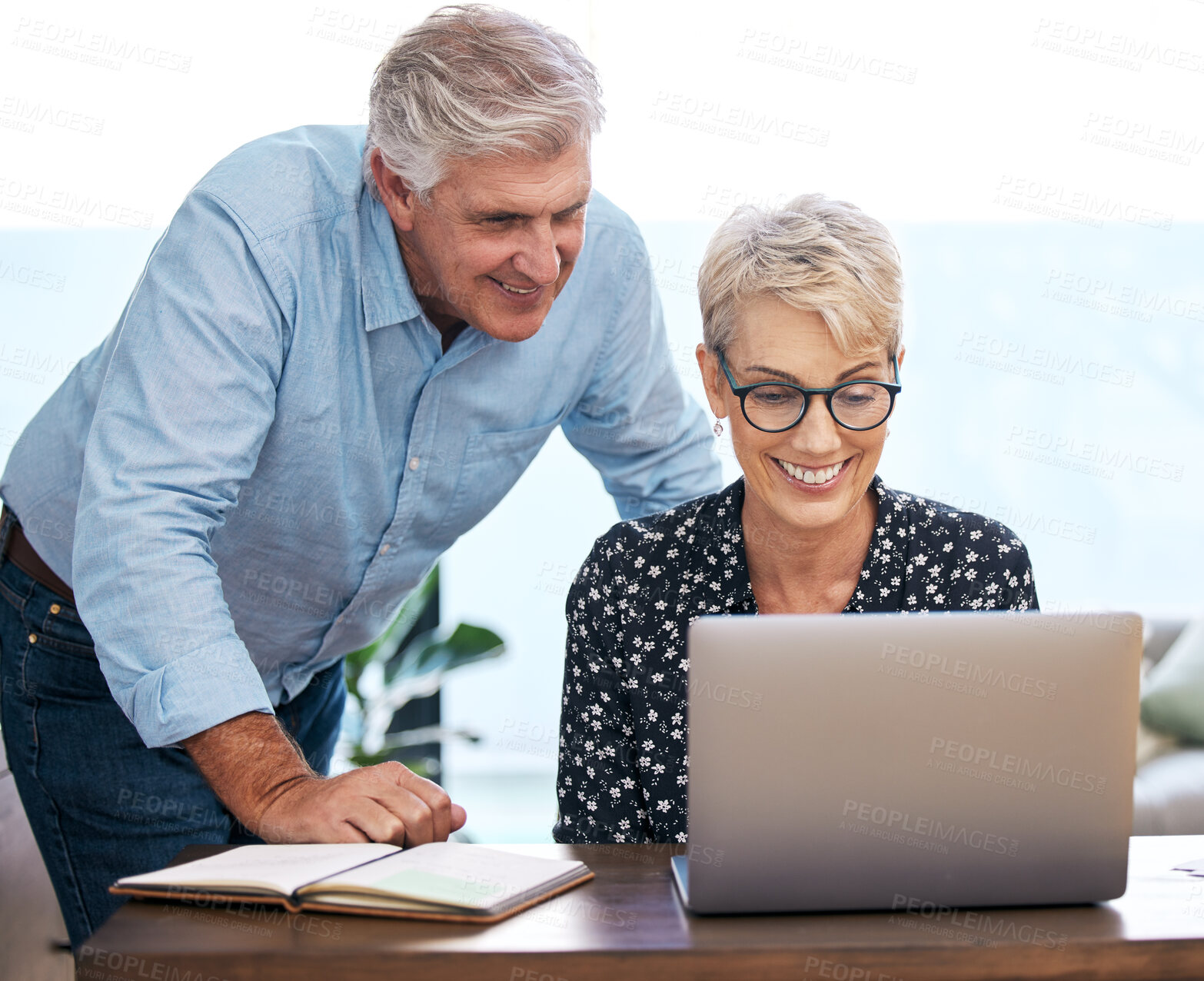 Buy stock photo Shot of a mature couple using a laptop at home