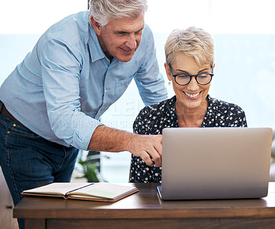 Buy stock photo Mature couple, laptop and smiling with choices for retirement, vacation and holiday at home. Woman on computer, man and excited for destinations for trip, browsing and budgeting in living room